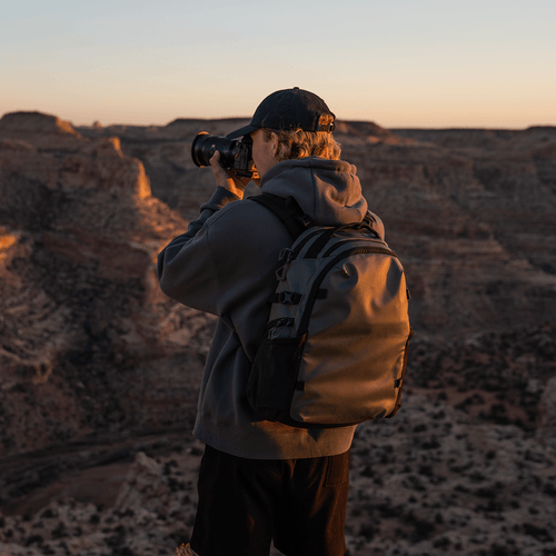 green-stratus-photo-18l-backpack-on-man-using-a-camera-variant_ids-41044451426384